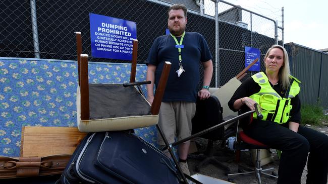 Springvale Vinnies shop manager Gavin Paulokat and Dandenong Council local laws officer Mel White with illegally dumped goods and rubbish at the back of the shop. Picture: Penny Stephens.