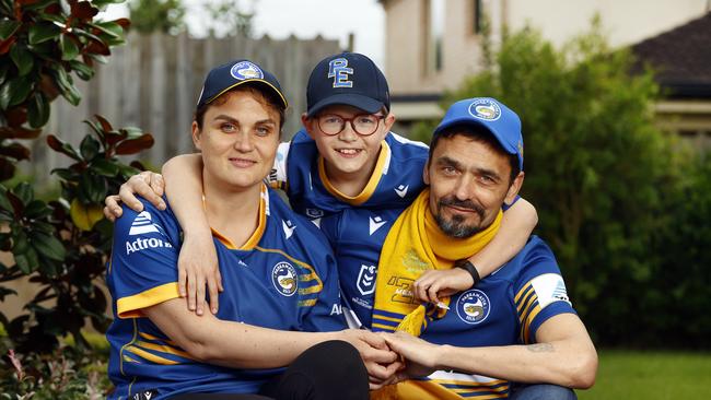 Ukrainian refugees Liza, Igor with their son Petre will enjoy the footy from a private box. Picture: Richard Dobson