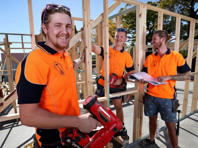 TAFE carpentry apprentices Ethan Sutherland and Karl Van Rijssen with apprentice manager Steve Purcell working on a 54-townhouse development at Richlands. Picture: Tara Croser.