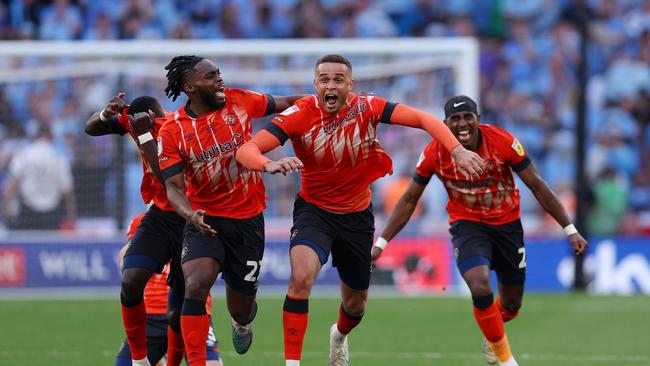 Players of Luton Town celebrate after Fankaty Dabo of Coventry City (not pictured) misses a penalty. (Photo by Richard Heathcote/Getty Images)