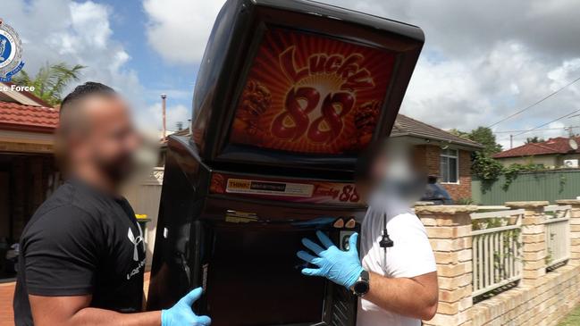 Police seize a poker machine in raid. Source: Police Media