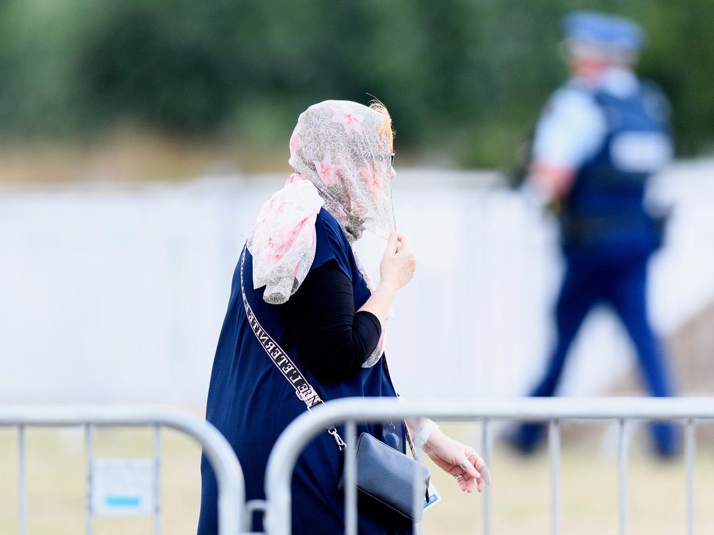 A woman walks past armed police officers prior to the first burials of victims at Memorial Park Cemetery on March 20, 2019. Picture: Kai Schwoerer/Getty Images