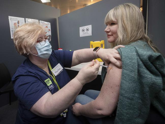 Chantelle Parrant of Kingston receives her second Pfizer vaccination from registered nurse Karina Skegg at the Moonah Vaccination Centre. Picture: Chris Kidd