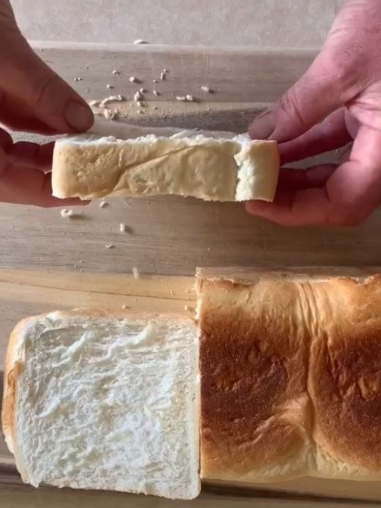 He cuts a loaf of white Bakers Delight bread into thick slices. Picture: TikTok/airfryerguy