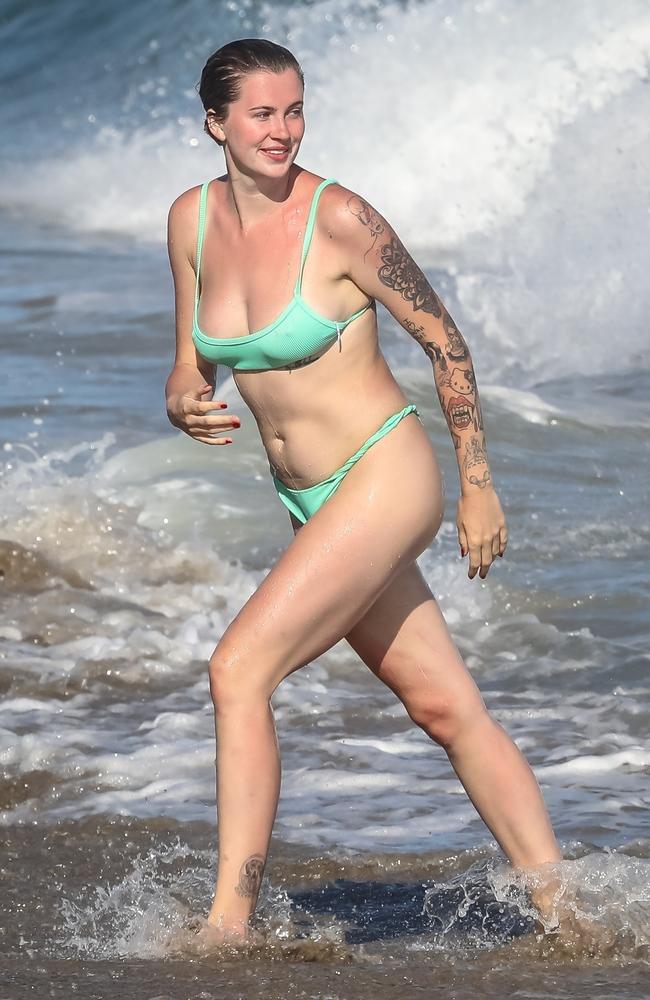 Ireland Baldwin takes a dip in the ocean to cool off as she enjoys a beach day in Malibu with her boyfriend and friends. Picture: Wagner AZ / RMBI / BACKGRID