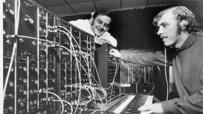 Radio presenter Bob Francis in the 5AD studios in Adelaide, watching as musician Phil Cunneen plays the electronic Moog musical synthesiser, on 31 October 1969. Picture: News Corp