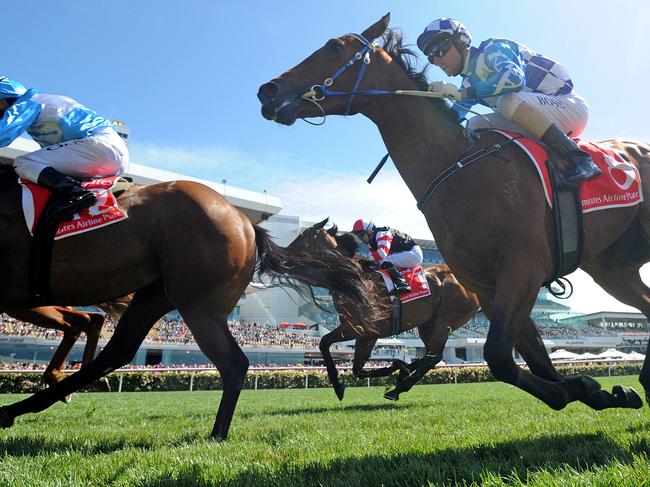 Jockeys ride their horses to the finish line during race 1, the Emirates Airline Plate, on Melbourne Cup Day at Flemington Racecourse in Melbourne, Tuesday, Nov. 3, 2015. (AAP Image/Joe Castro) NO ARCHIVING, EDITORIAL USE ONLY