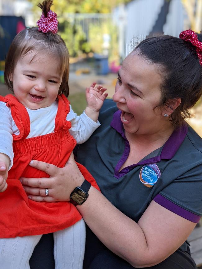 Goodstart Early Learning Tuggerah staff member playing and laughing with a child in their care.