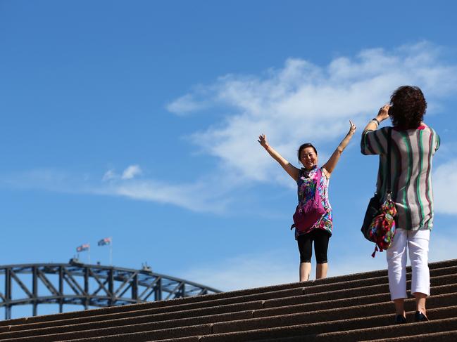 KOCH COLUMN : CHINA  ..   Chinese tourists take photographs in front of the Sydney Harbour Bridge in Sydney, Australia, on Monday, Dec. 24, 2012. At least 150,000 people from mainland China and across Asia are projected to descend on Sydney, Australia's most populous city, during the New Year's Eve and Chinese New Year period. Photographer: Brendon Thorne/Bloomberg via Getty Images