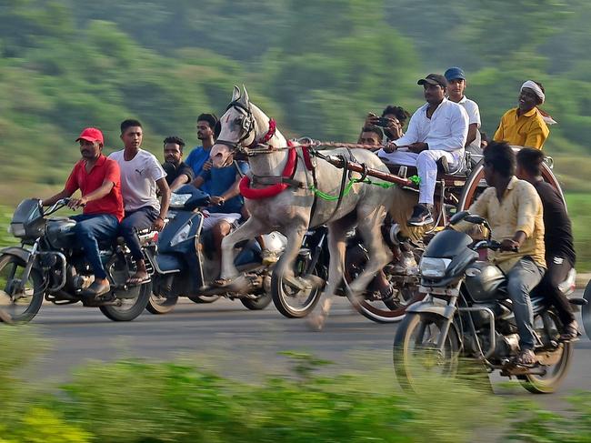 Participants take part in a horse-drawn cart race, an annual event during the holy month of Shravan in Prayagraj, India. Picture: Sanjay Kanojia / AFP