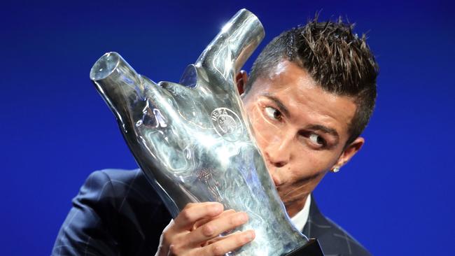 Real Madrid's Portuguese forward Cristiano Ronaldo kisses his trophy.