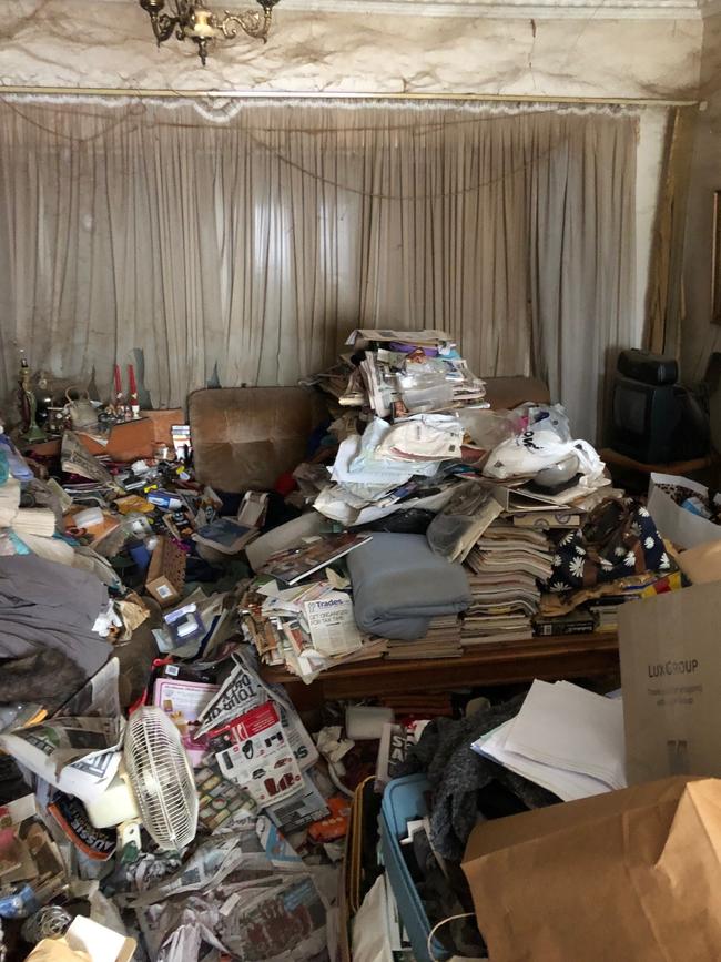 The filthy lounge room of the ‘Addams Family’ house.