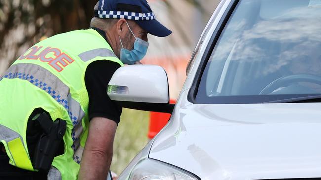 Police and the ADF at the Queensland border on Griffith Street, Coolangatta. Picture: Nigel Hallett.