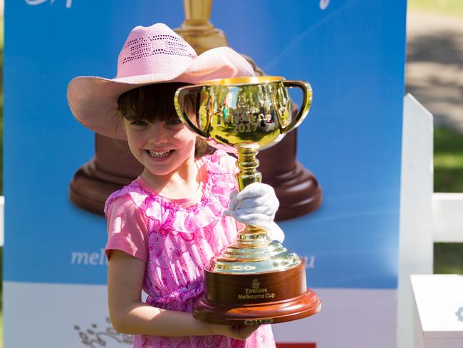 Lottie, 5, with the Emirates Melbourne Cup in Kununurra.