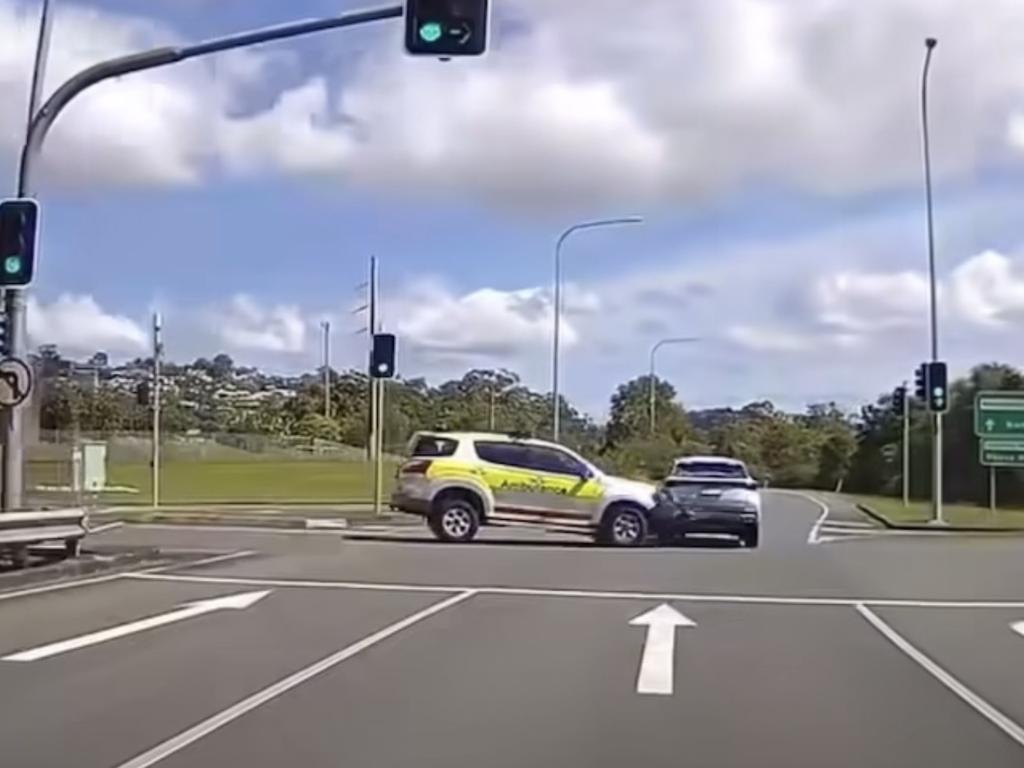 Dash cam footage shows the moment an ambulance with its lights on collides with another car on a busy intersection. Picture: Dash Cam Owners Australia