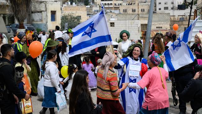 An Israeli MP celebrates Purim with the protection of security forces in the West Bank twon of Hebron this March. Picture: Getty Image