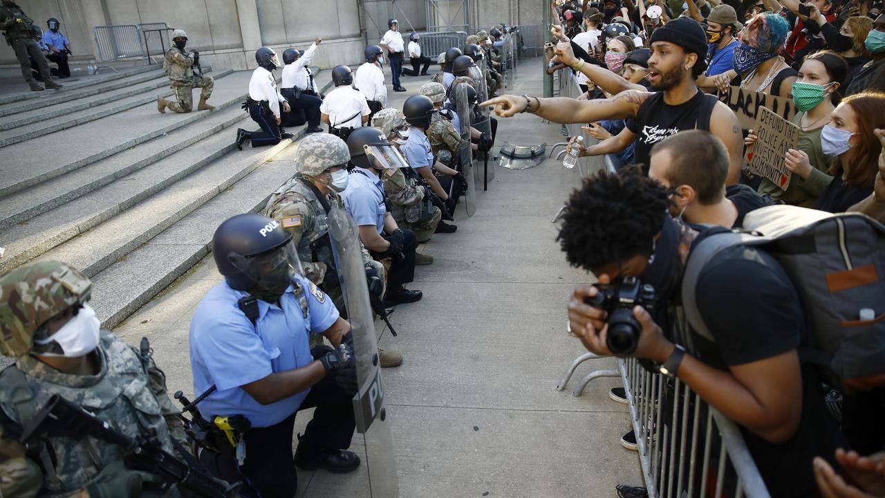 Philadelphia police and National Guard take a knee outside Philadelphia Police headquarters. Picture: Matt Slocum/AP