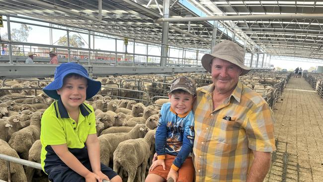 Richard Leahy from Howlong, NSW, and his twin grandsons Charlie and Billy, 5, at the Corowa lamb sale.