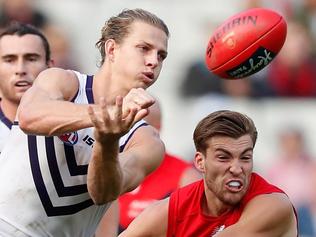 MELBOURNE, AUSTRALIA - APRIL 15: Nat Fyfe of the Dockers handpasses the ball ahead of Jack Viney of the Demons during the 2017 AFL round 04 match between the Melbourne Demons and the Fremantle Dockers at the Melbourne Cricket Ground on April 15, 2017 in Melbourne, Australia. (Photo by Adam Trafford/AFL Media/Getty Images)