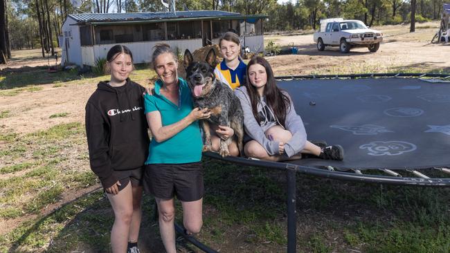 Big plans: Jane Rampling, pictured with her daughters and dog, Tradie, says some fellow “blockies” in Tara have much more basic amenities than her family’s humble home. Picture: Mark Cranitch.