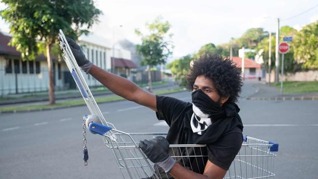 A resident watches over the roadblock set up by local residents to prevent the militia from passing through. Picture: AFP