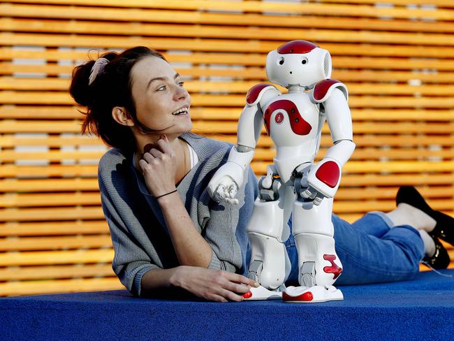 Kayla Robinson with Ruby the NAO Humanoid Robot. As part of Vivid Sydney, Rhodes will play host to a Human+Robot Friendship Ball. Picture: John Appleyard