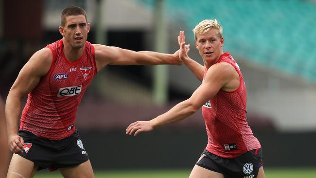 Darcy Cameron and Isaac Heeney jostle at Sydney Swans training. Picture: Phil Hillyard. 