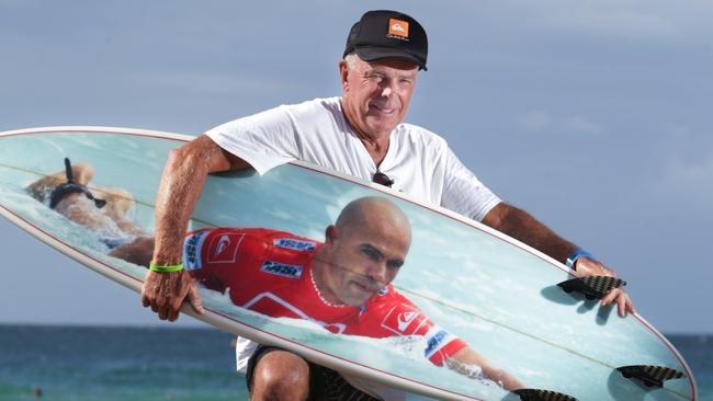 Gary Hill, 67, from Newcastle with his surfboard that has a picture of his surfing hero Kelly Slater on it. Gary is hoping for a signature from Kelly during the Quiksilver Pro. Pics Tim Marsden