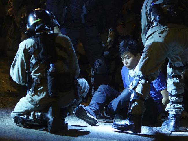 Riot police detain a protestor after he tried to escape from Hong Kong Polytechnic University in Hong Kong, Tuesday, Nov. 19, 2019. Picture: AP Photo/Vincent Yu