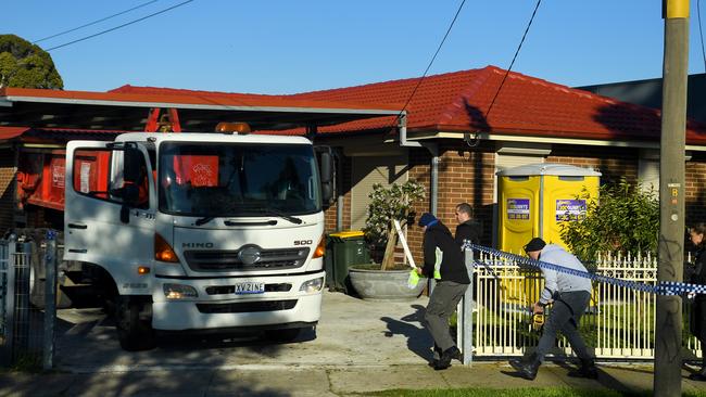 Police and excavation workers outside the home. Picture: AAP