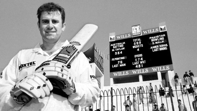 Cricketer Mark Taylor standing in front of scoreboard after making 334 not out in the second Test against Pakistan at Peshawar in 1998.