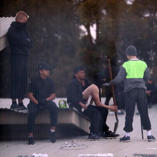 Inmates from the Frank Baxter Juvenile corrections centre Kariong taunt police from the roofs of various buildings. Some are armed with poles tennis rackets ect. Picture: John Grainger
