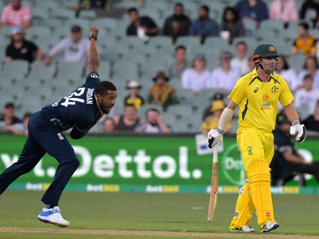 England's Chris Jordan bowls past Australia's Travis Head during the first one-day international (ODI) cricket match between Australia and England at the Adelaide Oval on November 17, 2022 in Adelaide. (Photo by Brenton Edwards / AFP) / -- IMAGE RESTRICTED TO EDITORIAL USE - STRICTLY NO COMMERCIAL USE --