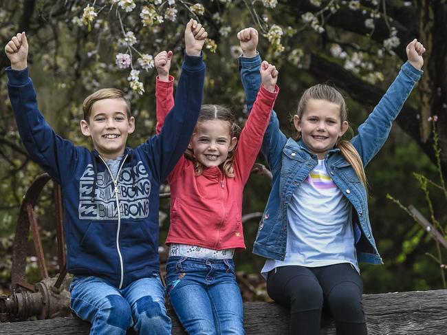 Willunga Almond Blossom Festival.Mitchell 10, Hilary 7 and Claire 4 with a historic Almond tree in the Willunga area.Thursday 18th July. 2019. Pic AAP / Roy VanDerVegt