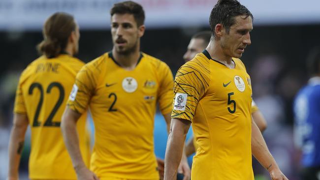 Australia's midfielder Mark Milligan, right, leaves the pitch with teammates at the end of the AFC Asian Cup group B soccer match between Australia and Jordan at Hazza bin Zayed stadium in Al Ain, United Arab Emirates, Sunday, Jan. 6, 2019. Jordan won 1-0. (AP Photo/Hassan Ammar)