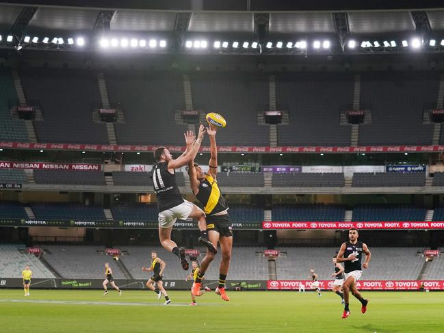 Mitch McGovern competes for the ball against Marlion Pickett in front of empty stands.