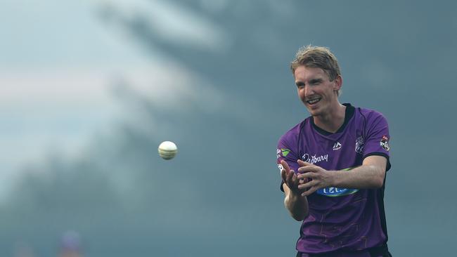 David Moody of the Hobart Hurricanes prepares to bowl as smoke from a nearby bushfire is seen over the ground during the Big Bash League match between the Hobart Hurricanes and the Brisbane Heat at Blundstone Arena tonight. Picture: GETTY