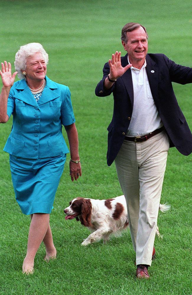 August 1992: President George H.W. Bush and first lady Barbara Bush walk with their dog Millie across the South Lawn. Picture: AP