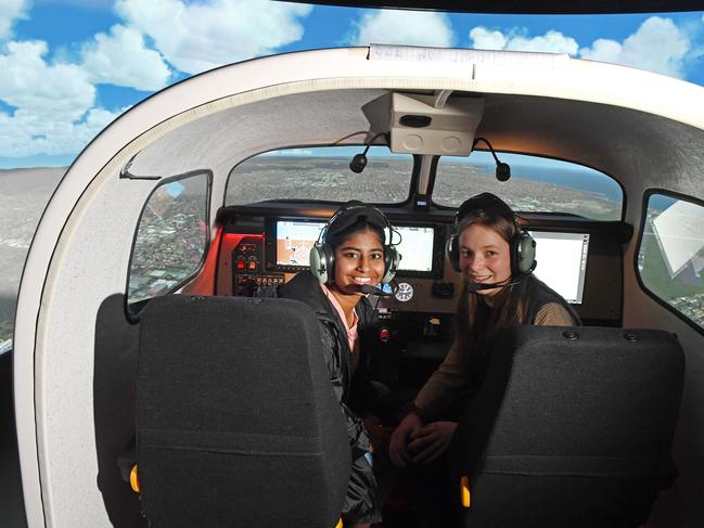 19/08/20 - Australian Science and Mathematics School  students Preethi Jeny  and Janay Will (0423 372 986) with a flight simulator.Picture: Tom Huntley