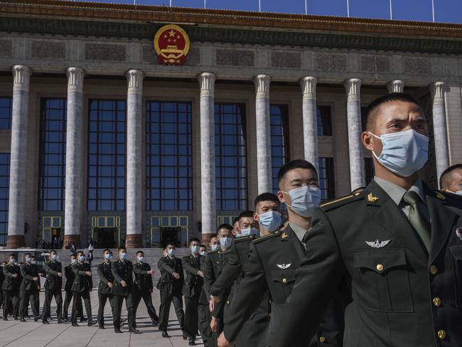 BEIJING, CHINA - OCTOBER 23: Chinese soldiers from the People's Liberation Army wear protective masks as they march after a ceremony marking the 70th anniversary of China's entry into the Korean War, on October 23, 2020 at the Great Hall of the People in Beijing, China. Chinese President Xi Jinping spoke at the event which was also attended by senior government and military officials and veterans of the war. (Photo by Kevin Frayer/Getty Images)