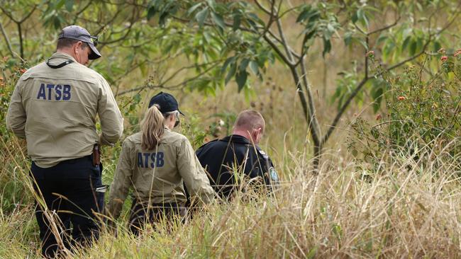 Police and ATSB investigators at the scene near Cedarton where two men were killed in a light plane crash. Picture: Lachie Millard