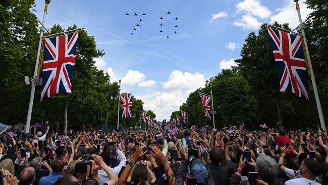 Spectators watch the RAF flypast on The Mall after the Trooping the Colour parade on June in London on Thursday night (AEST). Picture: Getty Images