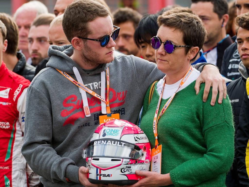 Brother and mother of BWT Arden's French driver Anthoine Hubert observe a minute's silence before the start of the Formula3 race.