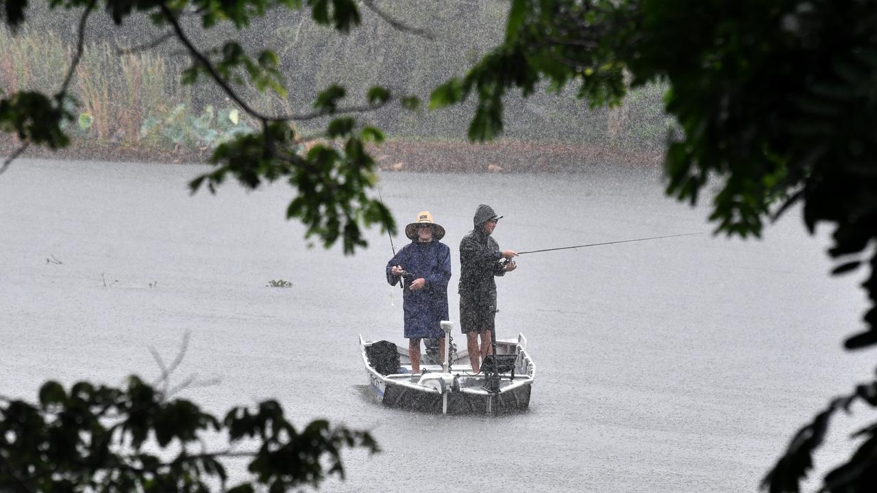 Wet weather in Townsville. Heavy rain does not stop fishing at Applins Weir. Picture: Evan Morgan