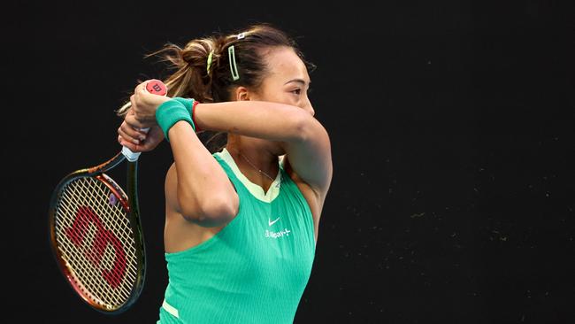 Zheng Qinwen hits a return against Aryna Sabalenka during the Australian Open final. Picture: David Gray/AFP.