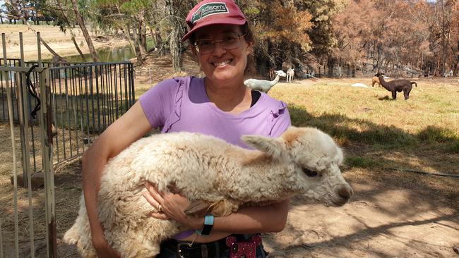 Debbie Redelman with month-old alpaca boy Qamdo. Photo: Isabell Petrinic