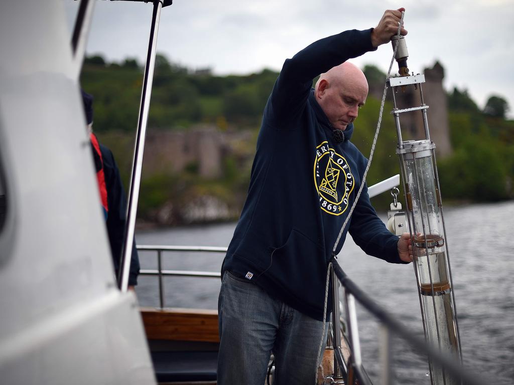 Professor Gemmell takes samples on his boat. Picture: AFP