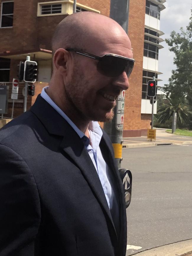 Matthew Samuel Becker grins after leaving Parramatta Local Court.