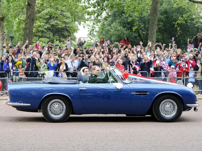 Prince William and Catherine their wedding day in the Mall in London in his father, Prince Charles’, Aston Martin Volante. Picture: Jonathan Short