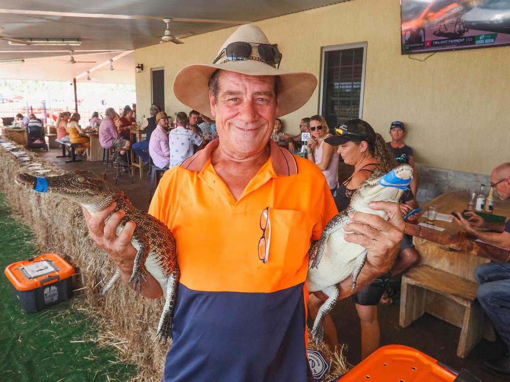 Croc racing at the Berry Springs Tavern for Melbourne Cup Day: John Whitwell, the ‘owner’ of these two crocs that competed in race two. Picture GLENN CAMPBELL